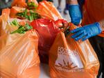 Fresh produce and shelf-stable pantry items are bagged for collection outside Barclays Center as Food Bank For New York City provides assistance to those in need due to the COVID-19 pandemic on Sept. 10, 2020.