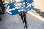 An election worker directs voters to a ballot drop-off location in 2020 in Portland, Ore. Oregon is among the states waiting for the Biden administration to greenlight plans to automatically register eligible voters when they apply to enroll in Medicaid.