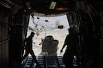 A Jordanian C-130 military aircraft performs an air drop of aid and supplies on July 31 over the Gaza Strip. The air drop was a joint effort with the United Arab Emirates Air Force and delivered 20 tons of food, baby milk and other basic items. Jordan and other regional governments have recently resumed air drops of aid as the humanitarian crisis, including lack of access to food, has worsened. 