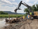 Heavy machinery drops logs in to McKay Creek at Ochoco Preserve on Aug. 1, 2022, during the first phase of a fish habitat restoration project.  The property will eventually be open to the public with hiking and biking trails, according to the Deschutes Land Trust.