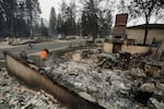 Chris Mutton, left, whose house burned in a wildfire speaks with Shane Maggart on Aug. 2, 2026, in Spokane, Wash.