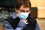 Parkland school shooter Nikolas Cruz, wearing glasses, a mask to cover his nose and moth, a black vest and a blue collared shirt, sits at the defense table, Wednesday, Oct. 20, 2021, at the Broward County Courthouse in Fort Lauderdale, Florida.