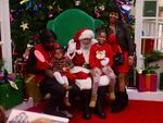 Ken Lee, far right, drove from Delaware with her family to take photos with Santa Luke at Mondawmin Mall.