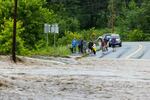 Onlookers check out a flooded road on July 10 in Chester, Vermont.