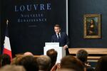 French President Emmanuel Macron gives a speech in front of the painting the Mona Lisa by Leonardo Da Vinci at the Louvre Museum in Paris on Tuesday.