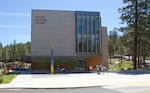 A boxy building surrounded by trees