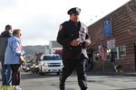 A police officer runs ahead of the memorial procession for slain Seaside Police Sgt. Jason Goodding.