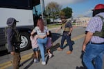 A woman from Peru and her children are detained and escorted to a bus by federal agents following an appearance at immigration court on June 23, 2025, in San Antonio.