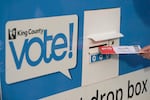 A person puts their ballot in a drop box on Oct. 27, 2020, at a library in Seattle. Under Washington state's primary system, the top two vote getters advance to the general election in November, regardless of party.