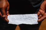 A rescue volunteer holds a note retrieved from artisanal miners operating underground written is isiXhosa language, reading, "We are requesting antiretroviral (ARV) pills. People are in need here. We are pleading with you," during a rescue operation in Stilfontein, South Africa, on Nov. 18.