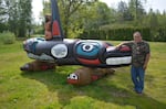 Lummi carver Jewell James stands with a totem pole he carved to urge the return of Tokitae the orca to Puget Sound.