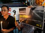 Thai activists hold a portrait of Netiporn Sanesangkhom, a member of the activist group Thaluwang outside of Criminal court in Bangkok, Thailand, on Tuesday.