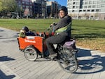 Lelac Almagor carries her son, 3-year-old Oren, and infant daughter, Tamar, in her e-cargo bike.