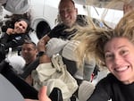 In this image posted by SpaceX following the first-ever commercial spacewalk by the Polaris Dawn crew, shows (L-to-R) mission specialist Sarah Gillis, commander Jared Isaacman, pilot Scott Poteet and mission specialist Anna Menon aboard a SpaceX Crew Dragon capsule.