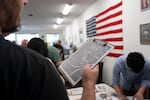A volunteer holds a map while gathering at the Washington County Democrats headquarters before canvassing begins.