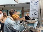 Minda Stiles and Constance Sullivan play with the Shellephone as Greta Gannon and Chet Udell look on at the Hatfield Marine Science Visitor’s Center in Newport, Ore., during a workshop for the Newport Chapter of the Association of Science Communicators on May 20, 2026.