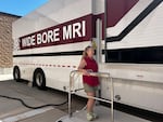 Patient Retta Jacobi stands on a metal platform that lifted her to the entrance of a mobile MRI unit at Southwest Healthcare Services in Bowman, North Dakota.