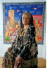 Artist Faith Ringgold sits before her quilt "Tar Beach" in 1993. The artwork also inspired a children's book of the same name.