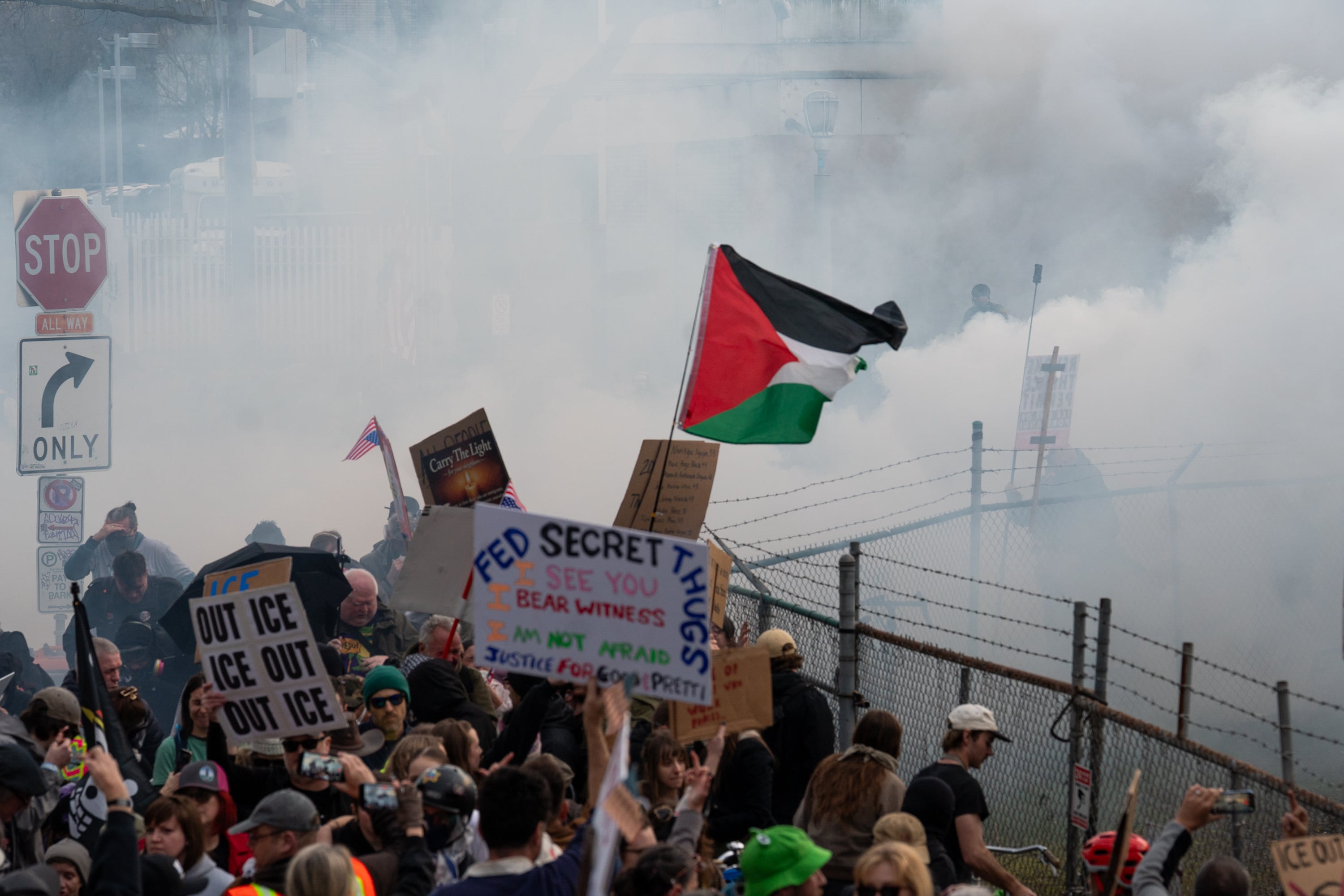 Thick clouds of tear gas, deployed by federal immigration officers, fill the air hundreds of protesters, including children and elderly people, try to escape outside of the ICE building in Portland, Jan. 31, 2026.