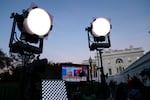 Spotlights for a media broadcast are lit in from of the White House on Election Night 2020.