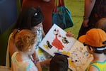 Melissa Mannke reads aloud during the opening day of the new Holgate Library building in Portland, Ore., on July 13, 2024.