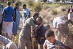 People comfort each other while digging graves for victims of the earthquake, in Ouargane village, near Marrakech, Morocco.