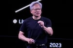 Nvidia CEO Jensen Huang delivers his keynote address on June 11, 2025, at the VivaTech fair in Paris. He's wearing a black T-shirt, dark pants and glasses while standing to give his address.