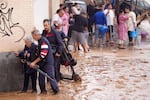 People walk through flooded streets in Valencia, Spain, on Wednesday, October 30, 2024.