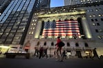 FILE - People pass the New York Stock Exchange on Nov. 5, 2024, in New York.