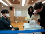 A family casts their votes for the parliamentary election at a polling station in Seoul, South Korea, Wednesday, April 10, 2024.