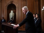 House Speaker Kevin McCarthy, R-Calif., pauses as he addresses reporters about efforts to pass appropriations bills and avert a looming government shutdown at the U.S. Capitol on Friday. He is joined at right by House Homeland Security Chair Mark Green, R-Tenn., and Rep. Monica de la Cruz, R-Texas.