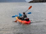 Celest Sorrentino (front) and Owen Fewell paddle out to sea in Port Orford to take samples of zooplankton, Aug. 19, 2026.