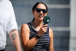 A person uses a fan to cool down in Trafalgar Square during the fifth heatwave of the season on Aug. 13, 2026, in London.