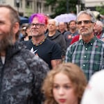 Chuck Bloom, left, and his partner Patrick Dacey, both from Portland, watch as drag artists perform on stage.