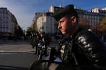 Riot police face high school students as they gather before a demonstration against under-resourced schools in Paris, Tuesday, Oct. 6, 2026.