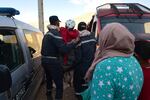 Walking wounded residents wait as rescue teams and civil protection members search the rubble for bodies of victims that perished in the devastating earthquake in Imi N'Tala, Morocco, on Sept. 13.