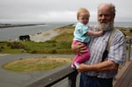 Bo Shindler and his granddaughter overlook the jetty where the Gold Beach jetty cats used to live.