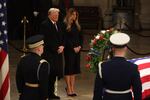 President-elect Donald Trump and former first lady Melania Trump pay their respects in front of the flag-draped casket of former President Jimmy Carter at the U.S. Capitol Rotunda in Washington, D.C., on Jan. 8.