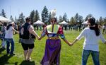 (center) A Quartz Creek dancer holds hands with attendees during a community round dance at the 24th annual Salmon Bake in Bend, Ore. on May 18, 2024.