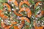 A hearty autumn salad of roasted pumpkin and lentils on a bed of arugula.