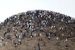 People gather on a hilltop close to the site of clashes near Fnideq, on the Morocco-Spain border on Friday.