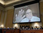 Rudy Giuliani's videotaped testimony appears on a video screen above members of the Select Committee to Investigate the January 6th Attack on the U.S. Capitol during its seventh hearing on July 12, 2022.