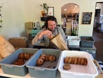 Josh Fairbanks packing up a bagel order at his Fairbanks Bread pop-up inside Ollini in Northeast Portland, Ore. on June 1, 2026.