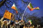 Protesters hold up placards and flags as they demonstrate outside the Iranian Embassy in London, Monday, Jan. 12, 2026.