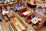 Diners sit at the Carver Hangar, a restaurant in Boring, Ore., on Jan. 6, 2021. As coronavirus deaths soar, a growing number of restaurants like Carver Hangar in states across the country are reopening in defiance of strict COVID-19 rules that have shut them down for indoor dining for weeks, or even months.