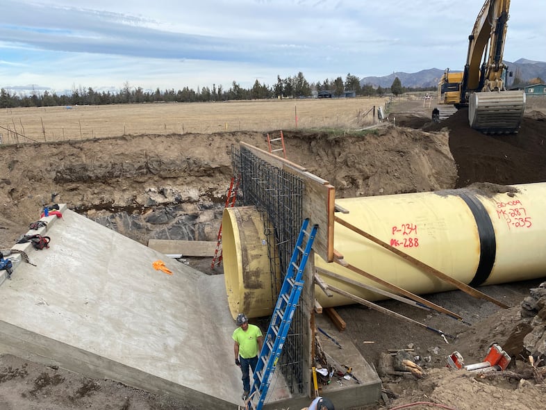 In this provided image, workers pipe a main canal for Central Oregon Irrigation District, March 23, 2023.