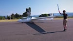 Fox Gossett, age 15, finishes his preflight check before his first solo flight. Jonathan Hart, another member of the Hood River Soaring youth program, volunteers to be his ground crew.