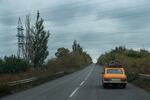 A car loaded with suitcases and a bicycle heads west on the main highway from Dobropillya, Ukraine, in October. The number of displaced people fleeing the Pokrovsk region has grown as Russian troops continue a steady advance on the coal producing area.