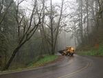 Oregon Department of Transportation road crews work to clear the Historic Columbia River Highway of fallen rocks. Heavy rain has caused landslides and flooding.