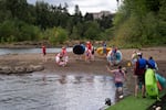 People get ready to float on Elk Rock Island. 